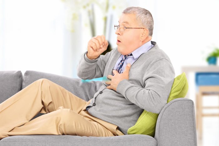 ASTHMA man coughing on the sofa shutterstock  e