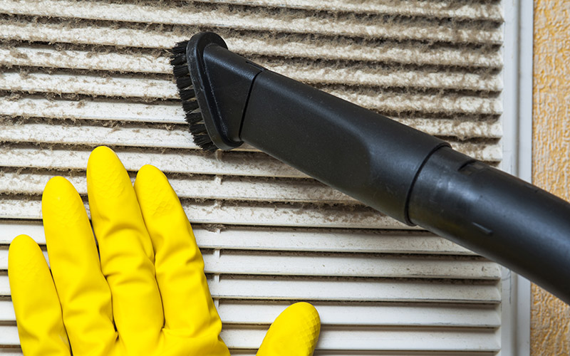 Hand In Yellow Glove And Vacuum Cleaner Pipe